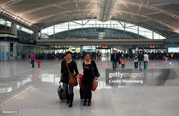 Passengers walk through the new Guangzhou South Railway Station in Guangzhou, China, on Tuesday, Feb. 2, 2010. The new CRH Wuhan-Guangzhou train...