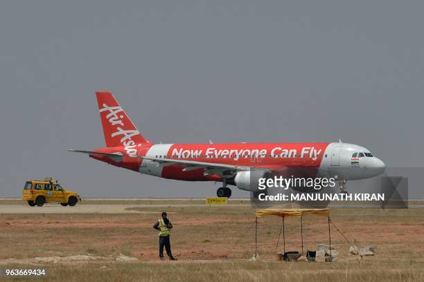 This photograph taken on March 8, 2018 shows an airplane of Air Asia, the low-cost airline headquartered in Malaysia, preparing to take off at the...