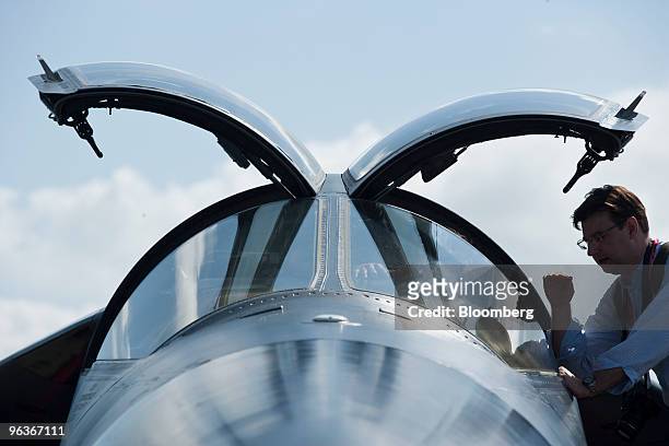 An attendee looks in the cockpit of a General Dynamics F-111 Aardvark jet at the Singapore Airshow, in Singapore, on Wednesday, Feb. 3, 2010. The...