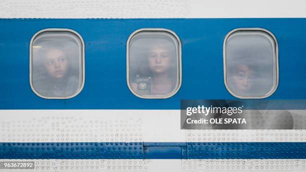 Children from the region around Chernobyl in the Ukraine look out of the window of a plane after arriving at the airport in Hanover, central Germany,...