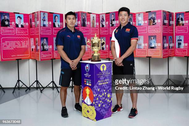 Former Chinese National players Li Yang and Han Xiaolong poses for a photo with the Webb Ellis Cup at the Beijing National Day School Longyue as part...