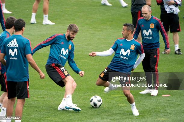 Spain's defender Gerard Pique, Spain's midfielder Thiago and Spain's midfielder Andres Iniesta attend a training session at the Spanish Football...