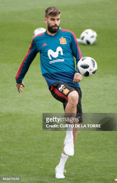 Spain's defender Gerard Pique controls a ball during a training session at the Spanish Football Federation's "Ciudad del Futbol" in Las Rozas, near...