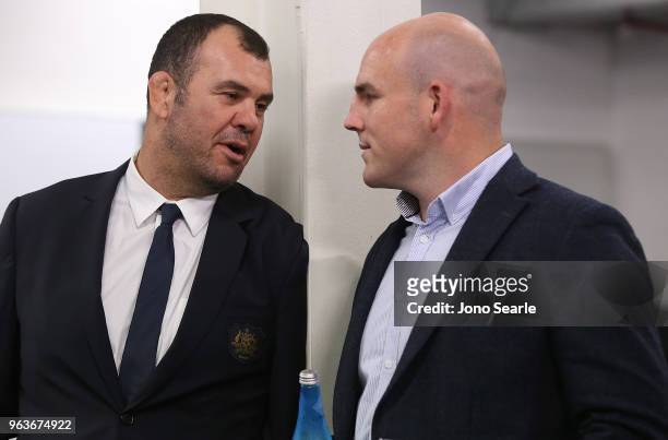 Michael Cheika, Wallabies coach, talks with former Wallabies captain Stephen Moore during the Australia Wallabies squad announcement at Suncorp...