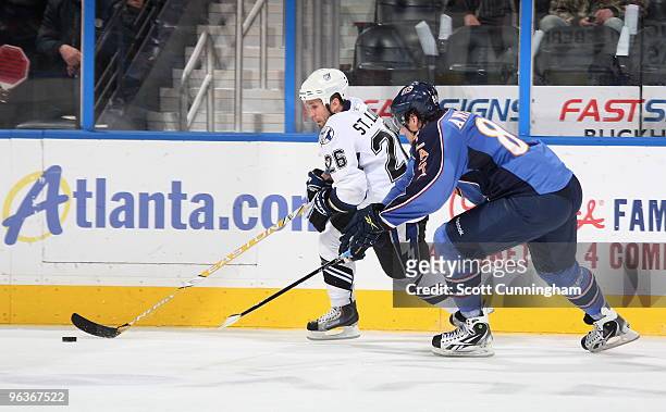 Martin St. Louis of the Tampa Bay Lightning carries the puck against Nik Antropov of the Atlanta Thrashers at Philips Arena on February 2, 2010 in...