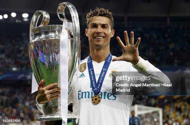 Cristiano Ronaldo of Real Madrid celebrates with The UEFA Champions League trophy following his sides victory in the UEFA Champions League Final...