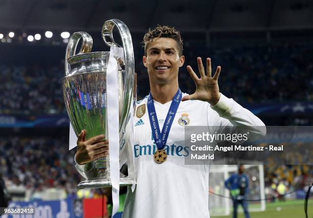 Cristiano Ronaldo of Real Madrid celebrates with The UEFA Champions League trophy following his sides victory in the UEFA Champions League Final...