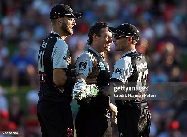 Nathan McCullum celebrates with Daniel Vettori and Brendon McCullum of New Zealand after bowling Shakib Al HasanÊof Bangladesh out during the...