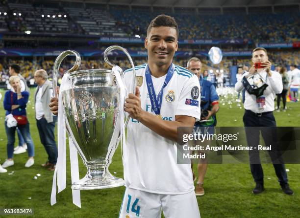 Casemiro of Real Madrid celebrates with The UEFA Champions League trophy following his sides victory in the UEFA Champions League Final between Real...