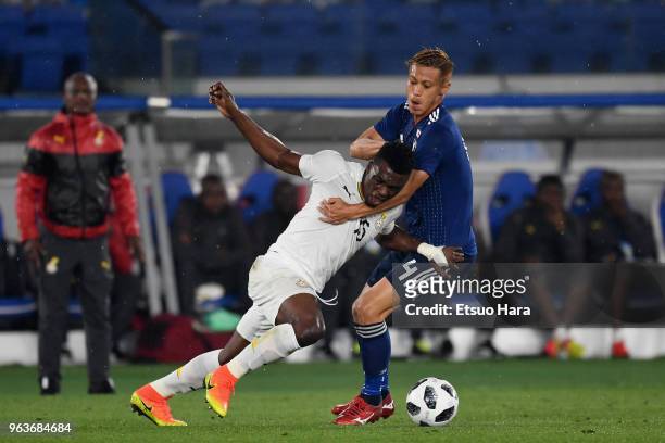 Rashid Sumaila of Ghana and Keisuke Honda of Japan compete for the ball during the international friendly match between Japan and Ghana at Nissan...