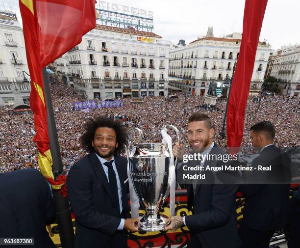 Captains Sergio Ramos and Marcelo of Real Madrid celebrate with the Champions League trophy at Puerta del Sol a day after winning their 13th European...