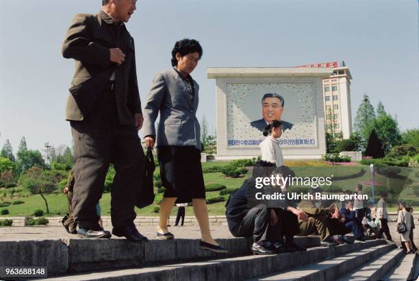 Street scene with Kim Il Sung image, soldiers and civilians in Pjoenjang, the capital of the People's Republic of North Korea .