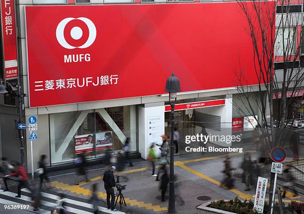 Pedestrians walk past a branch of Bank of Tokyo Mitsubishi UFJ in Tokyo, Japan, on Wednesday, Feb. 3, 2010. Mitsubishi UFJ Financial Group Inc.,...