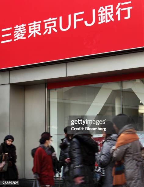 Pedestrians walk past a branch of Bank of Tokyo Mitsubishi UFJ in Tokyo, Japan, on Wednesday, Feb. 3, 2010. Mitsubishi UFJ Financial Group Inc.,...