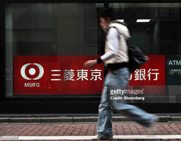 Man walks past a branch of Bank of Tokyo Mitsubishi UFJ in Tokyo, Japan, on Wednesday, Feb. 3, 2010. Mitsubishi UFJ Financial Group Inc., Japan's...
