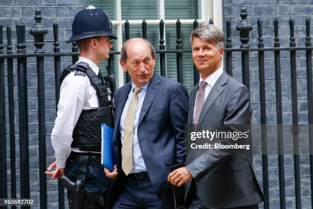 Paul Bulcke, chairman of Nestle SA, center, and Harald Krueger, chief executive officer of Bayerische Motoren Werke AG , right, arrive for a meeting...