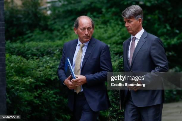 Paul Bulcke, chairman of Nestle SA, left, and Harald Krueger, chief executive officer of Bayerische Motoren Werke AG , arrive for a meeting of...