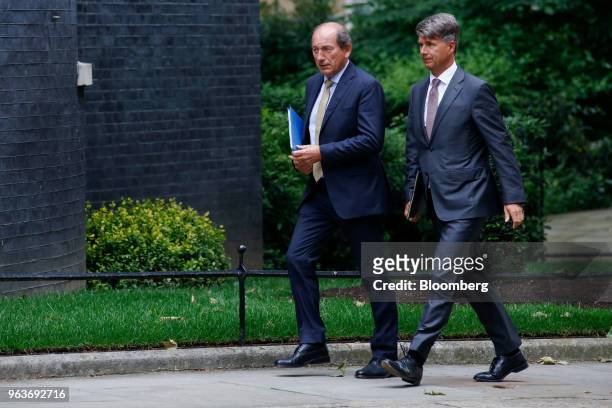 Paul Bulcke, chairman of Nestle SA, left, and Harald Krueger, chief executive officer of Bayerische Motoren Werke AG , arrive for a meeting of...