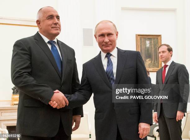 Russian President Vladimir Putin shakes hands with Bulgarian Prime Minister Boyko Borissov during their meeting in the Kremlin in Moscow on May 30,...