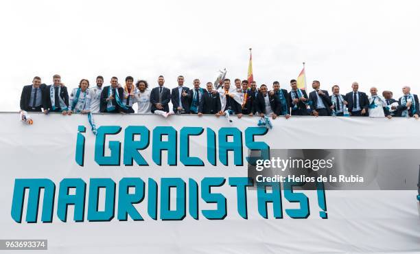 The players of Real Madrid holds up the Champions League trophy with his teammate Marcelo as they celebrate at Cibeles Square a day after winning...