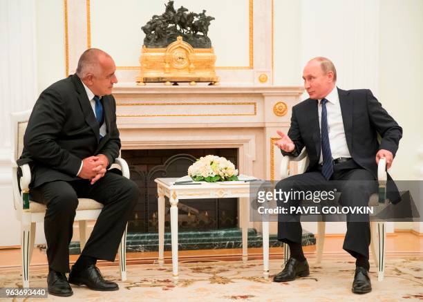 Russian President Vladimir Putin speaks to Bulgarian Prime Minister Boyko Borissov during their meeting in the Kremlin in Moscow on May 30, 2018.