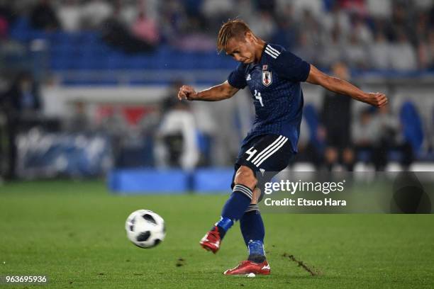 Keisuke Honda of Japan takes a free kick during the international friendly match between Japan and Ghana at Nissan Stadium on May 30, 2018 in...