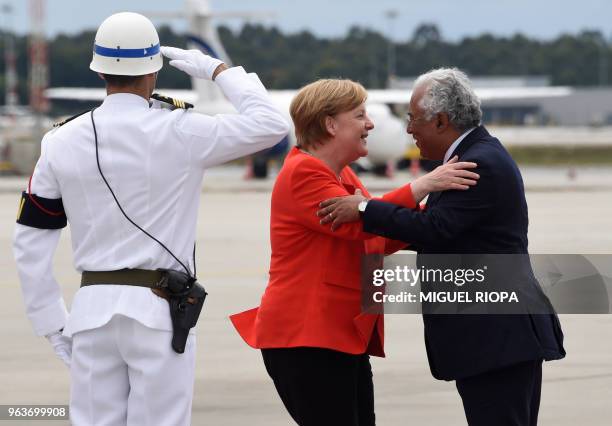 German Chancellor Angela Merkel is welcomed by Portuguese Prime Minister Antonio Costa, upon her arrival at the Francisco Sa Carneiro airport for a...