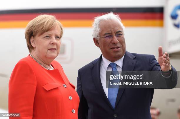 German Chancellor Angela Merkel is welcomed by Portuguese Prime Minister Antonio Costa, upon her arrival at the Francisco Sa Carneiro airport for a...