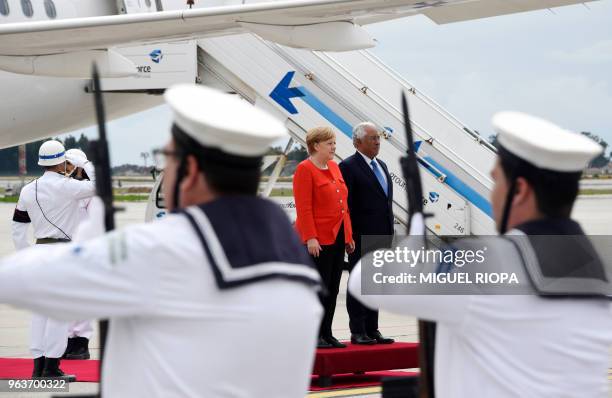 German Chancellor Angela Merkel and Portuguese Prime Minister Antonio Costa inspect the troops upon Merkel's arrival at the Francisco Sa Carneiro...