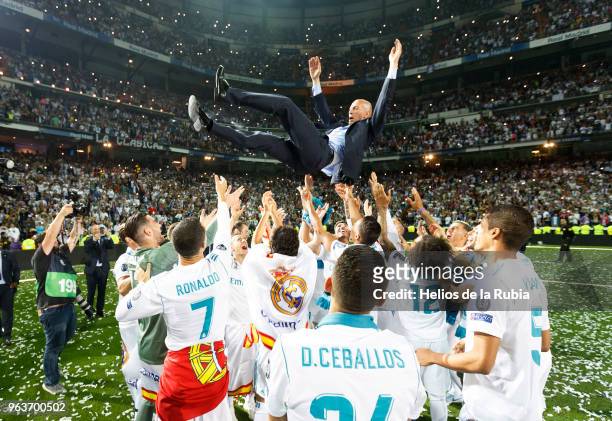 Zinedine Zidane, Manager of Real Madrid is thrown in the air by his players during Real Madrid team celebration at Santiago Bernabeu Stadium after...