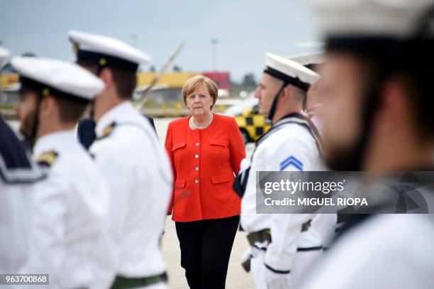 German Chancellor Angela Merkel inspects the troops with Portuguese Prime Minister upon her arrival at the Francisco Sa Carneiro airport for a...