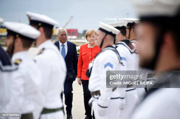 German Chancellor Angela Merkel inspects the troops with Portuguese Prime Minister Antonio Costa upon her arrival at the Francisco Sa Carneiro...