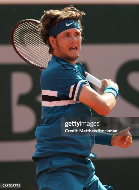 Jared Donaldson of The United States plays a forehand during the mens singles second round match against Grigor Dimitrov of Bulgaria during day four...