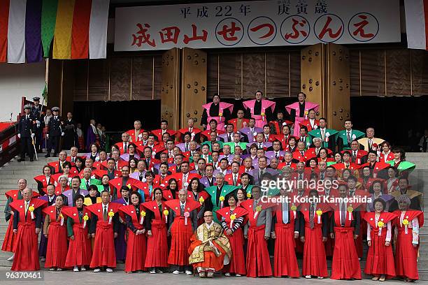 Sumo wrestlers and TV actors and actresses pose for photographers during a bean-scattering ceremony at Shinshoji Temple on February 3, 2010 in...