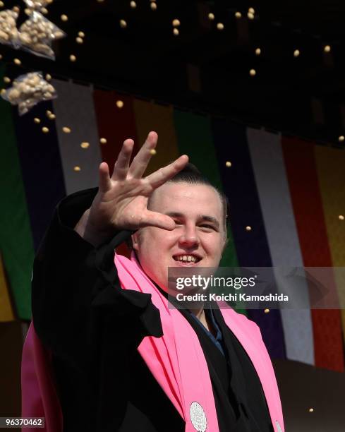 Sumo Wrestler Baruto from Estonia throws packs of beans during a bean-scattering ceremony at Shinshoji Temple on February 3, 2010 in Narita, Japan....