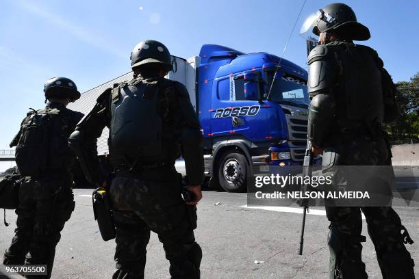 Soldiers take part in an operation to clear highway Regis Bittencourt, 30 km from Sao Paulo, on May 30, 2018 as a truckers' strike against rising...