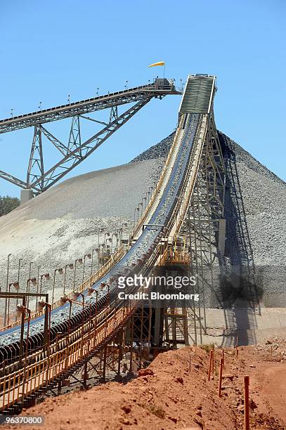 The primary conveyor belt transports crushed rock to the first stage of the gold separation process at Newmont Mining Corp.'s Boddington Gold mine,...