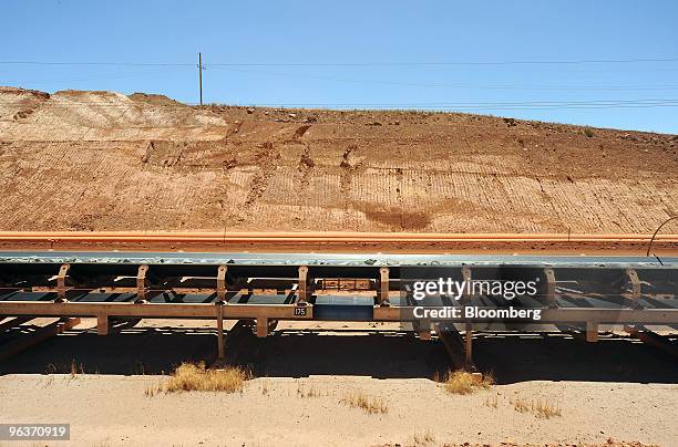 The primary conveyor belt transports crushed rock to the first stage of the gold separation process at Newmont Mining Corp.'s Boddington Gold mine,...