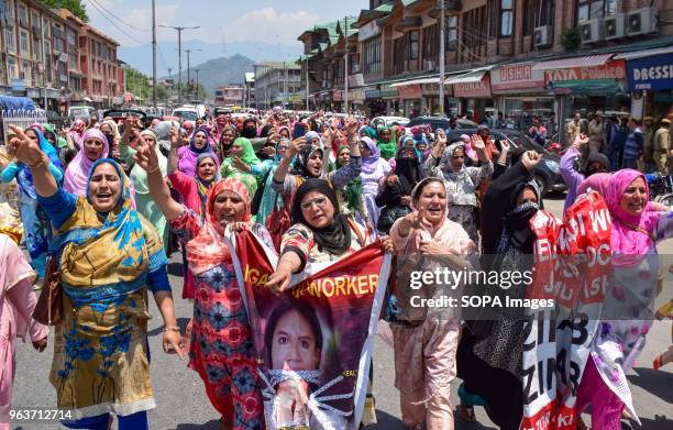 Anganwadi rural mother and child care centre workers shout anti-government slogans during a demonstration against the government in city centre Lal...