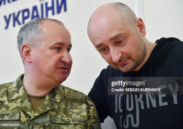 Russian anti-Kremlin journalist Arkady Babchenko and head of Ukraine's security service Vasyl Grytsak react during a press conference at Ukrainian...