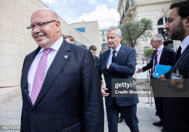 Peter Altmaier, Germany's economy minister, left, and Bruno Le Maire, Frances finance minister, center, depart a trilateral meeting with European...