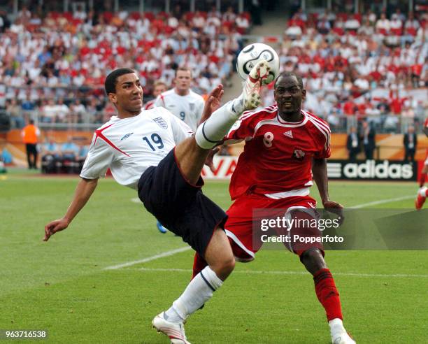 Aaron Lennon of England and Cyd Gray of Trinidad & Tobago in action during the FIFA World Cup Group B match between England and Trinidad & Tobago at...