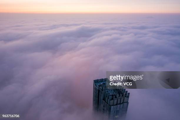 Advection fog surrounds office buildings and residential buildings on May 29, 2018 in Yantai, China.