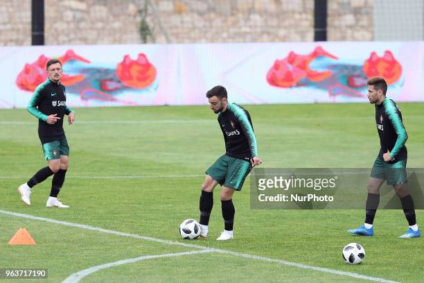 Portugal's defender Mario Rui , Portugal's midfielder Bruno Fernandes and Portugal's defender Raphael Guerreiro in action during a training session...