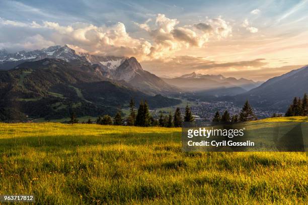 sunset at a mountain pasture over garmisch-partenkirchen - scenery stock pictures, royalty-free photos & images