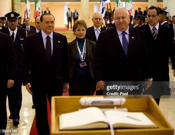 Italian Prime Minister Silvio Berlusconi walks with Reuven Rivlin the Speaker of the Knesset, Israel's parliament, as he arrives to sign the Knesset...