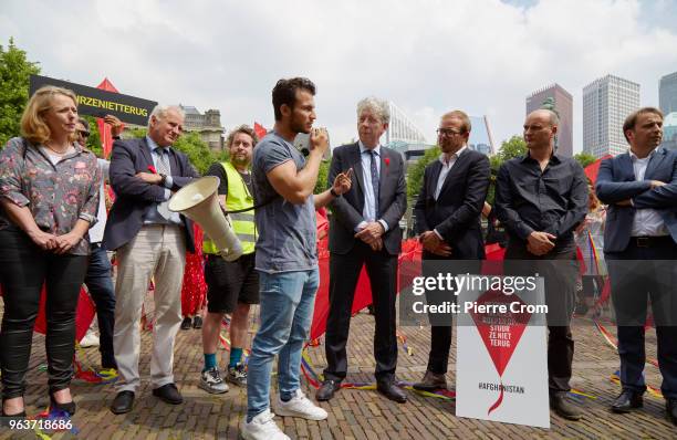 An Afghan refugee speaks out as human rights group Amnesty International hands over a petition signed by more the 68,000 people to the Dutch...