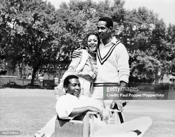 Actors Hal Frederick and Esther Anderson pose with West Indian cricketer Garfield Sobers on the set of the film Two Gentlemen Sharing, in London...