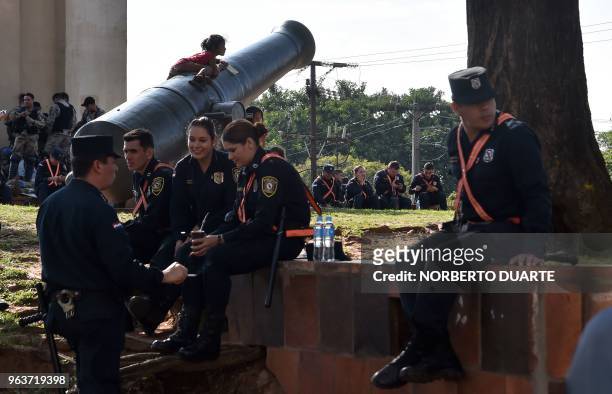 Police officers are seen at a square in the surroundings of the Congress in Asuncion on May 30 after the parliament failed to reach a quorum to vote...