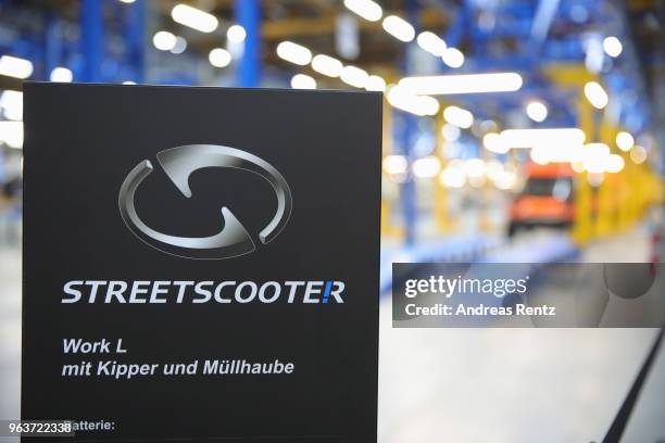 Workers assemble StreetScooter electric delivery vans at the StreetScooter plant on May 30, 2018 in Dueren, Germany. Deutsche Post DHL,...